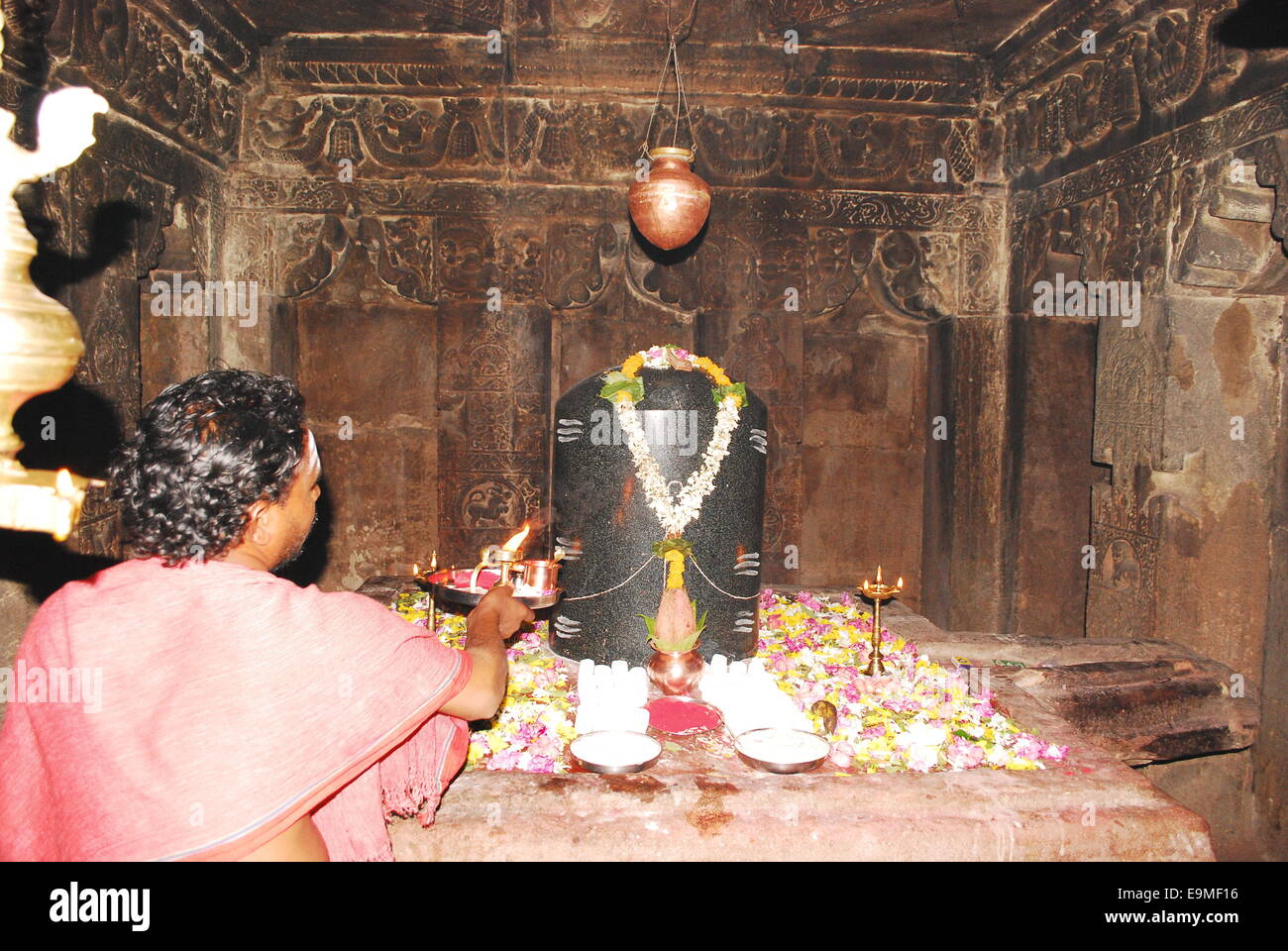 A Brahman priest makes a puja to Shiva Lingam, Pattadakal, south India Stock Photo