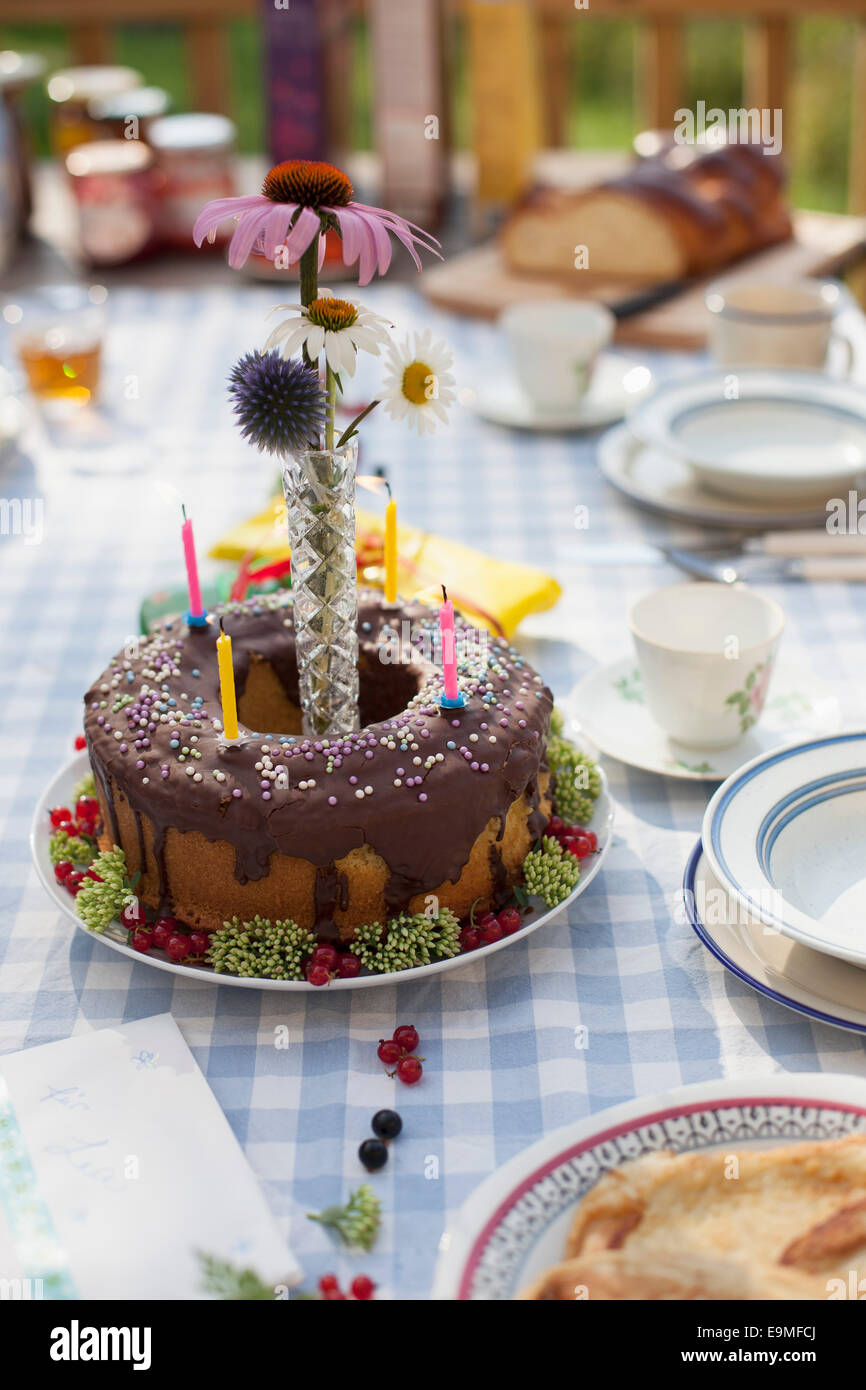 Decorated birthday cake on dining table at yard Stock Photo