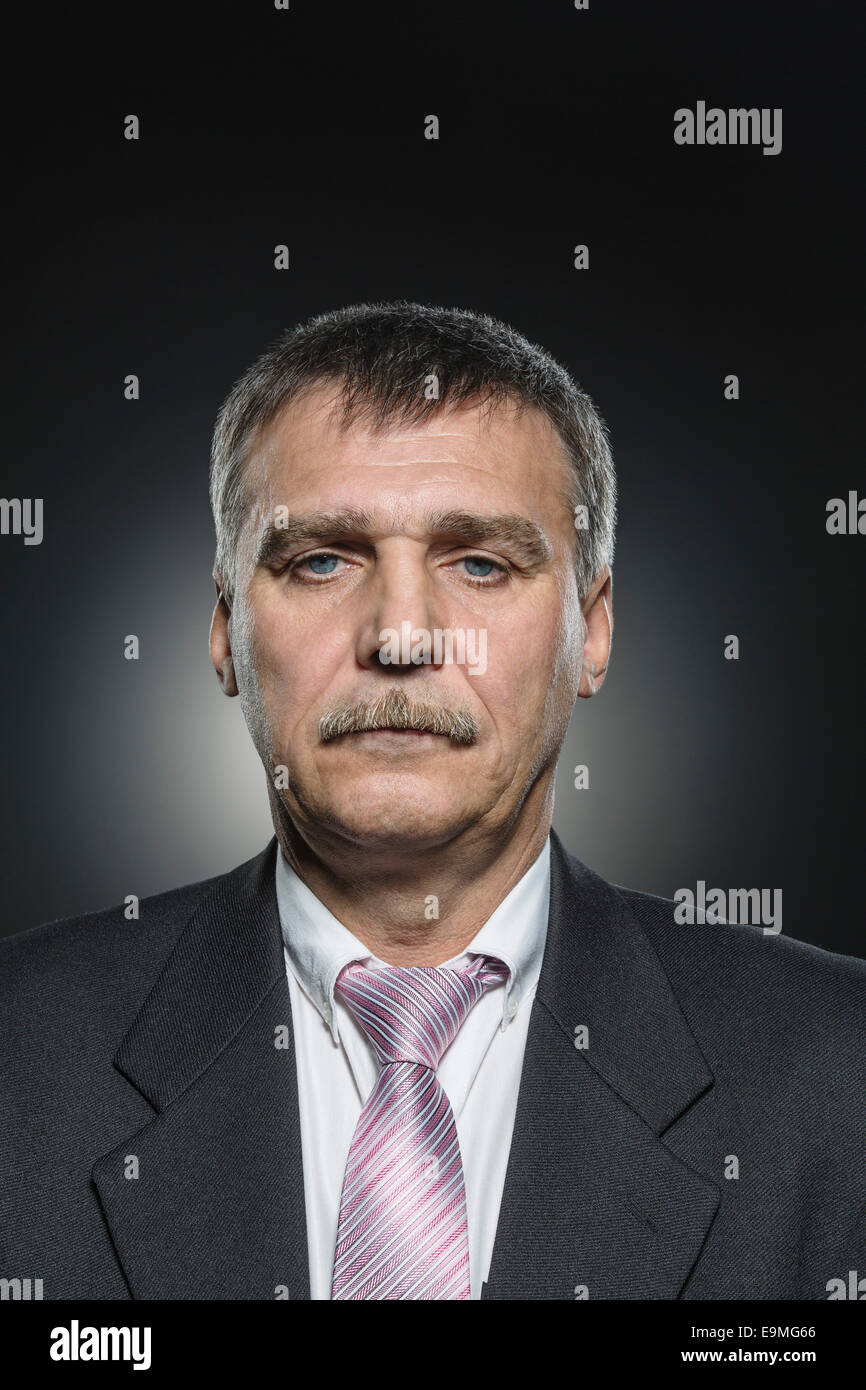 Portrait of confident businessman against black background Stock Photo