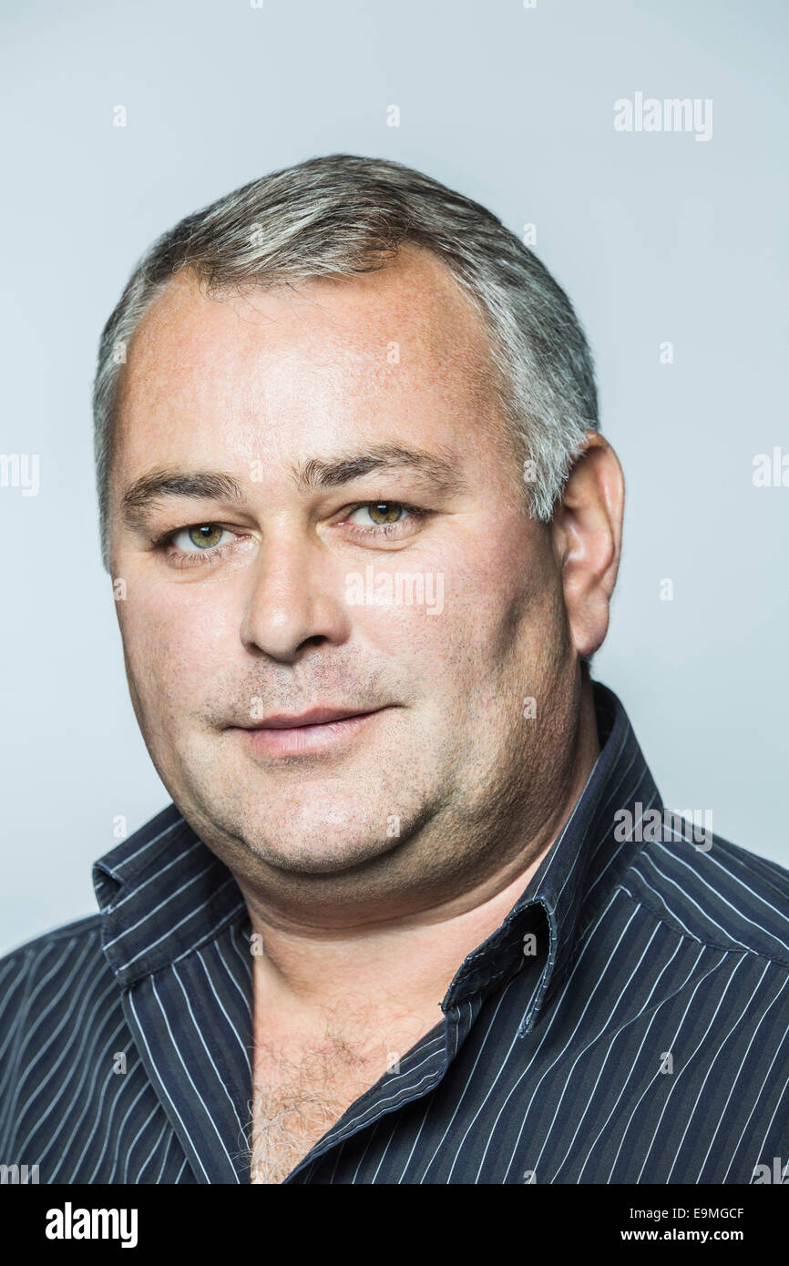Portrait of confident businessman against gray background Stock Photo