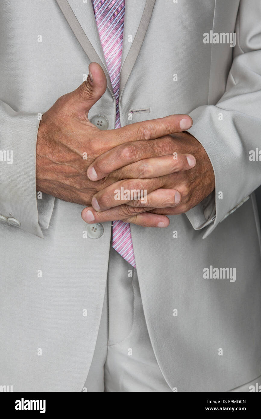 Midsection of businessman standing with hands clasped Stock Photo
