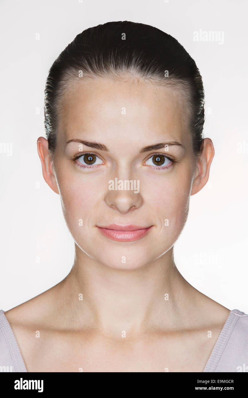 Close-up portrait of beautiful young woman against white background ...
