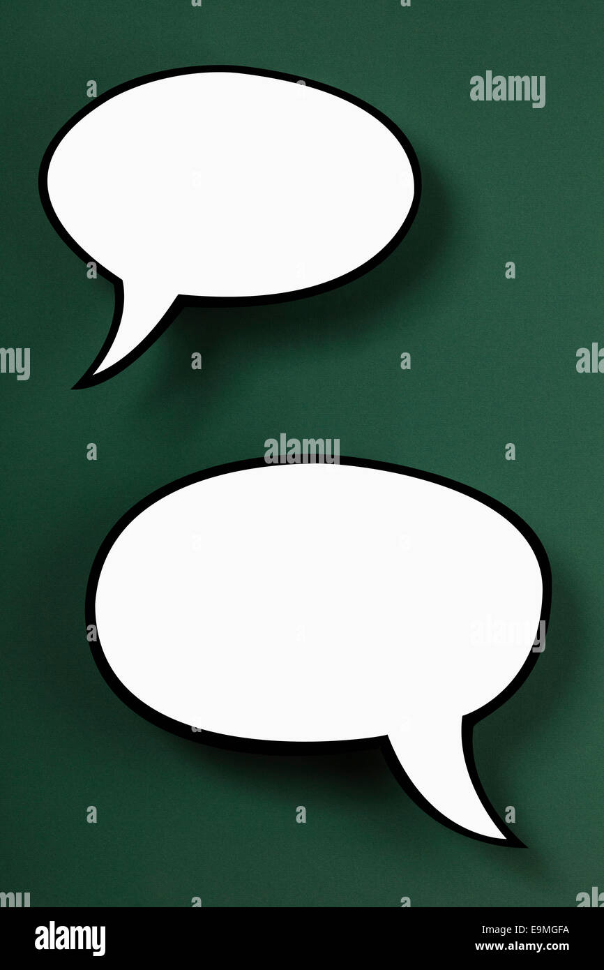 Blank speech bubbles against green background Stock Photo