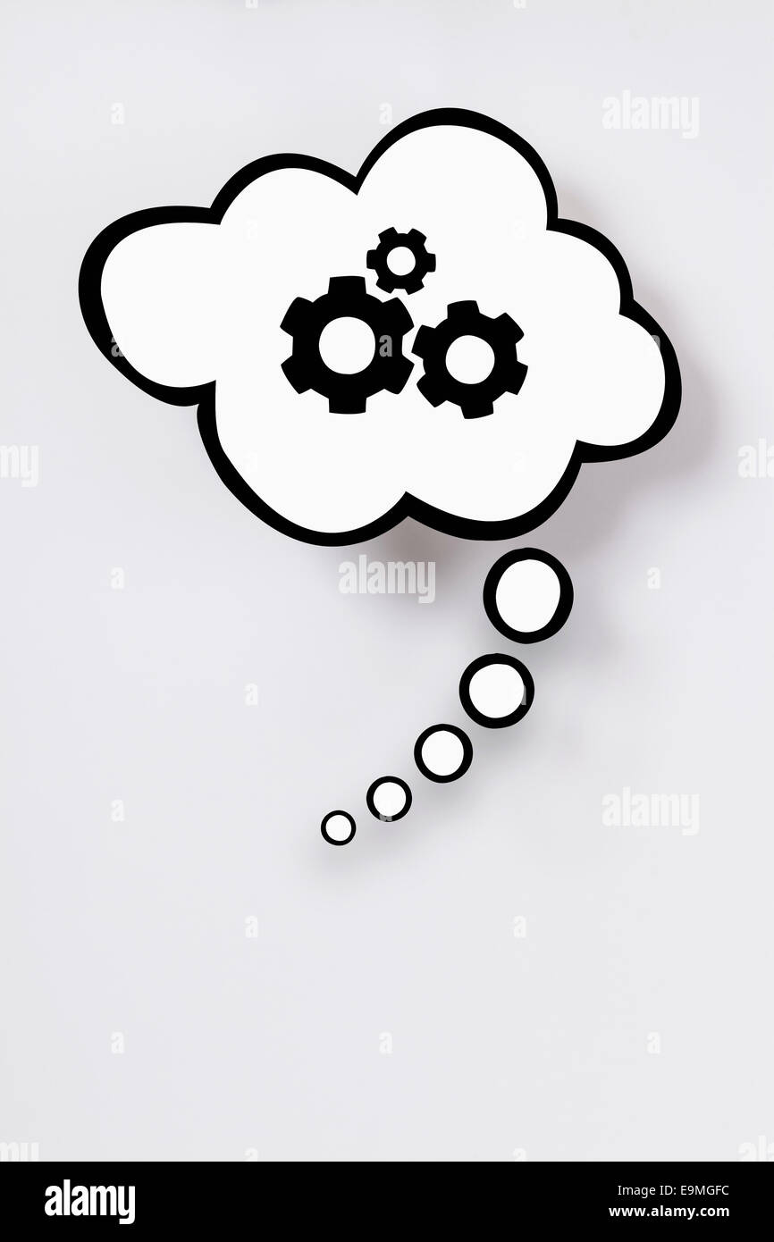 Thought bubble with gears against gray background Stock Photo