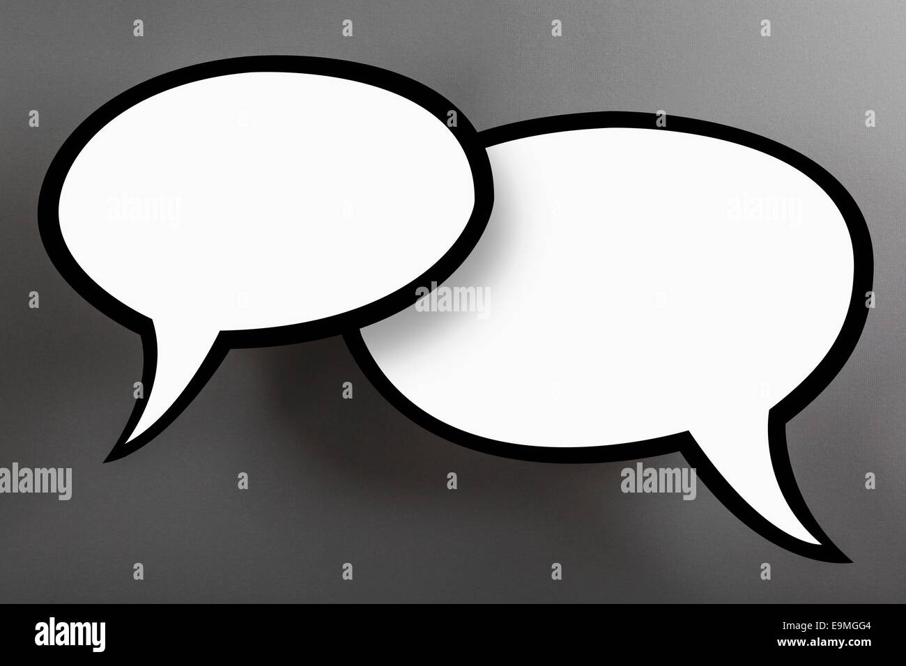 Blank speech bubbles against gray background Stock Photo