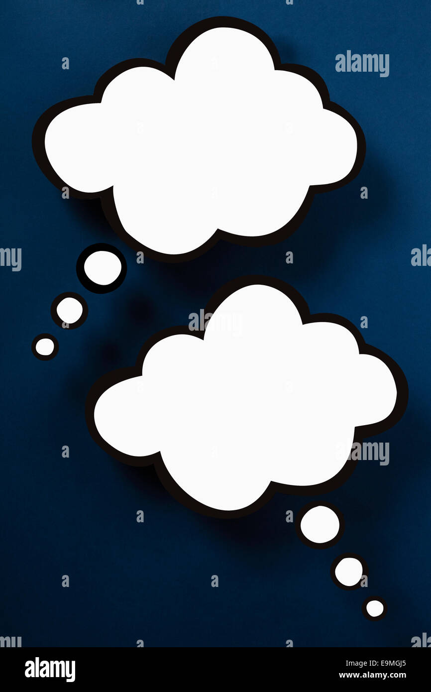Blank thought bubbles against blue background Stock Photo