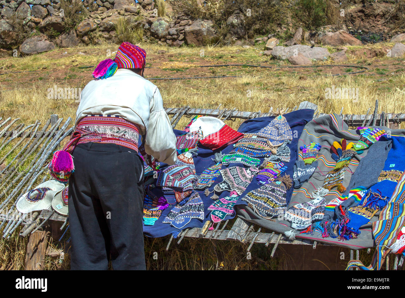 Man arranging the chullo hats on the display in Peru Stock Photo