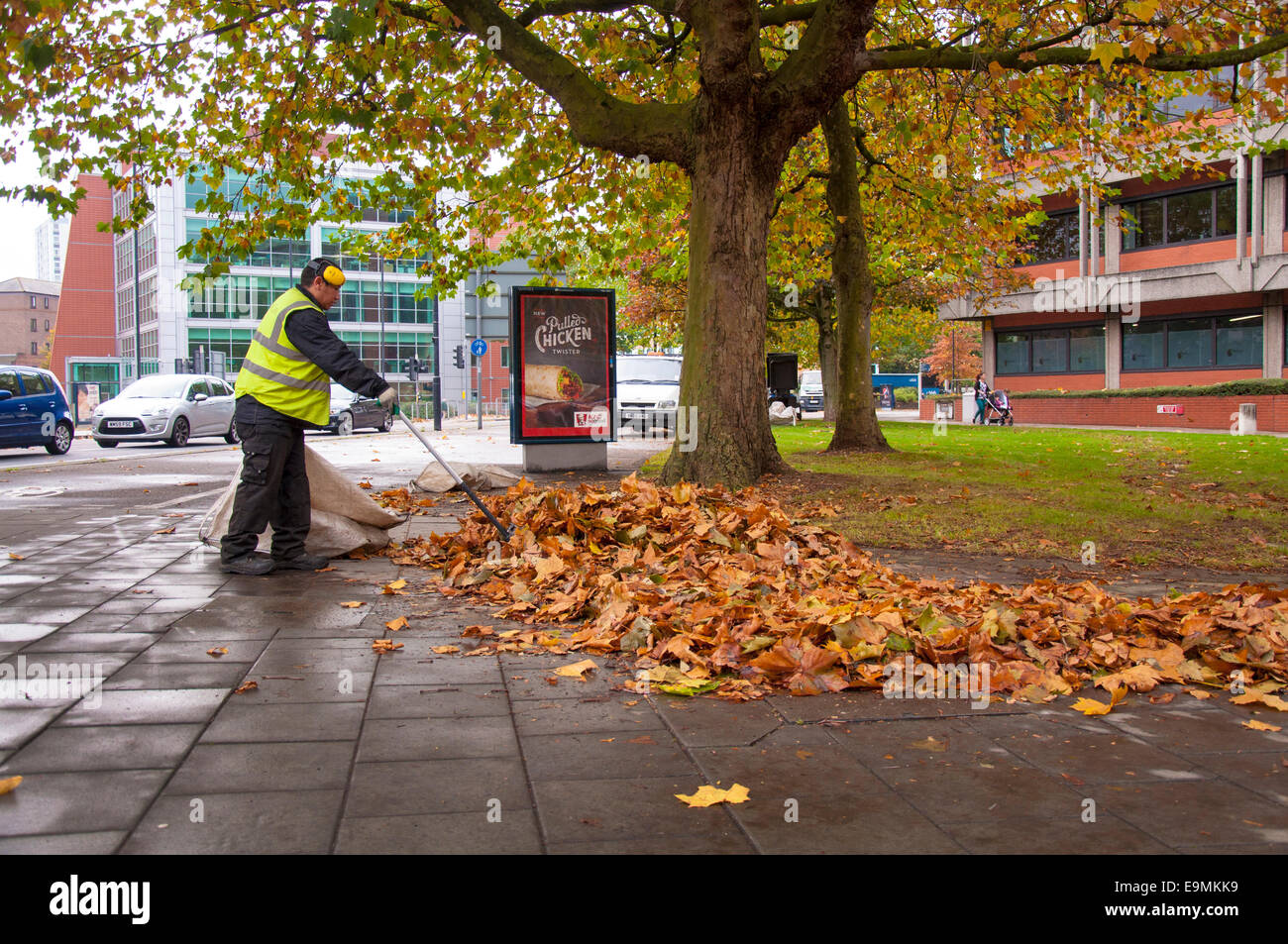 Bristol, UK. Council workers removing autumn leaves in the city centre