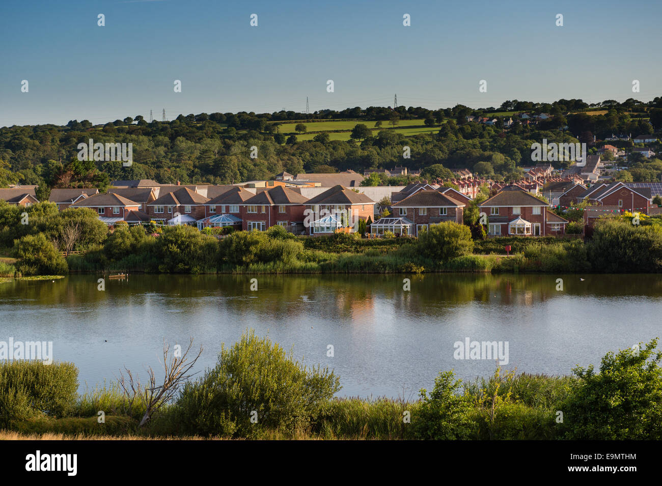 Waterside lakeside detached new modern houses by the  Millennium Park, Llanelli, Carmarthenshire Wales UK Stock Photo