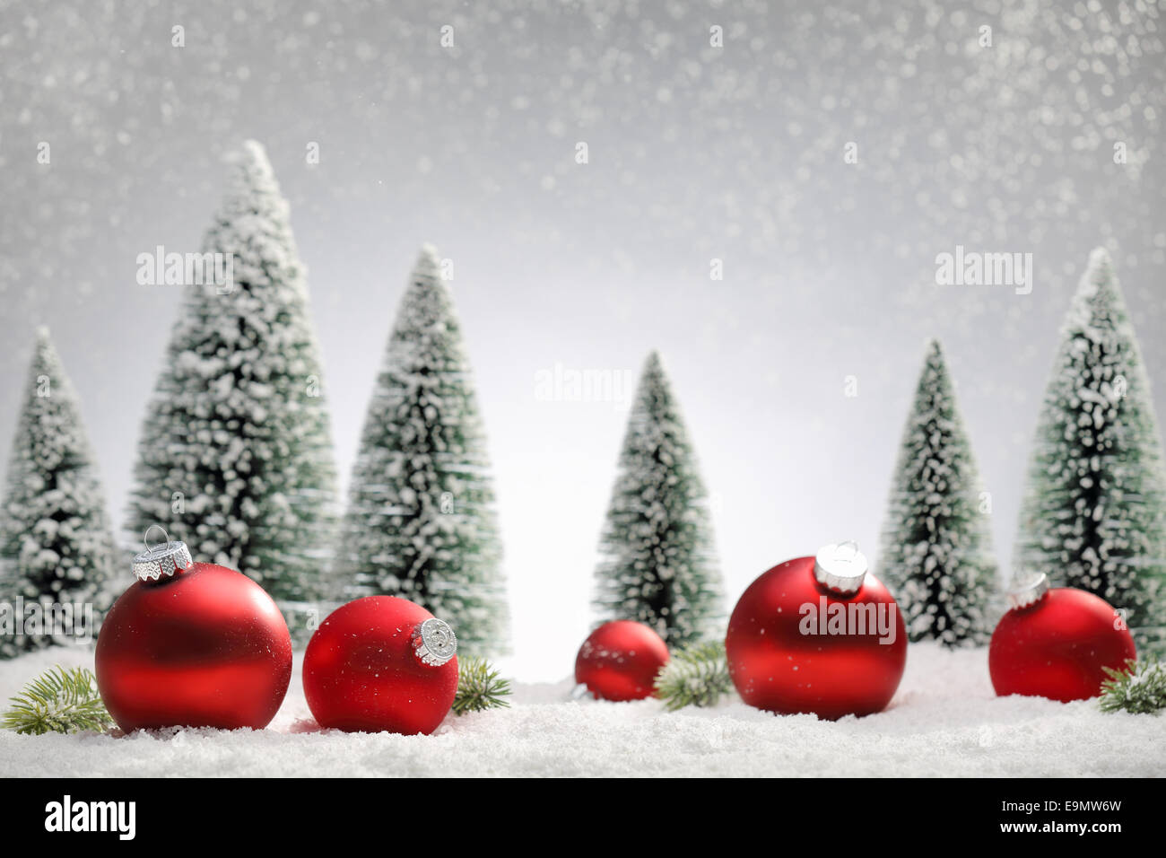 Red Christmas balls and fir tree on snow Stock Photo