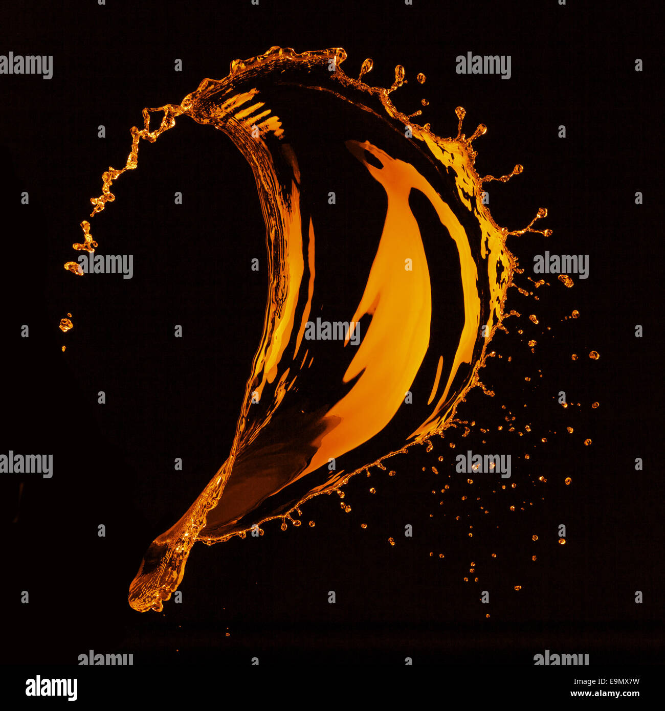 orange water splash isolated on black Stock Photo - Alamy