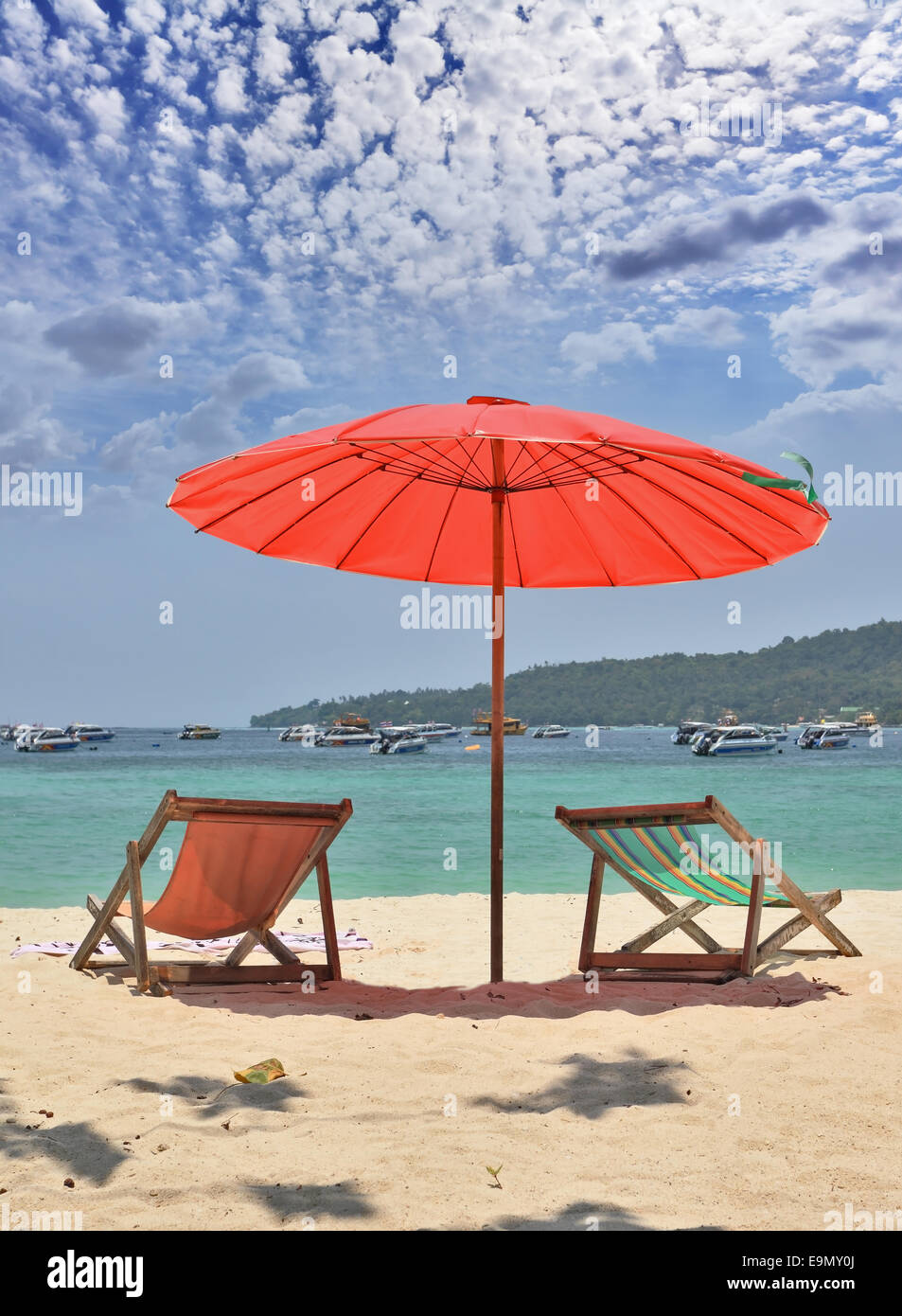 Red beach umbrella and deck chairs Stock Photo Alamy