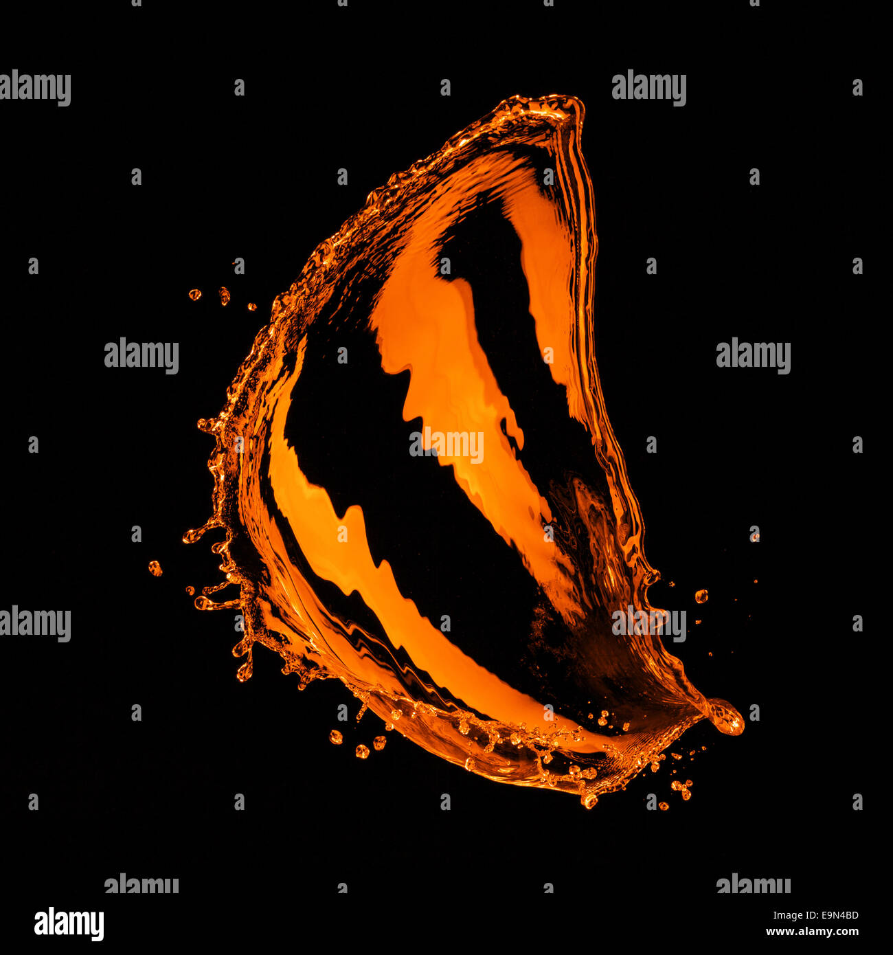 orange water splash isolated on black Stock Photo - Alamy
