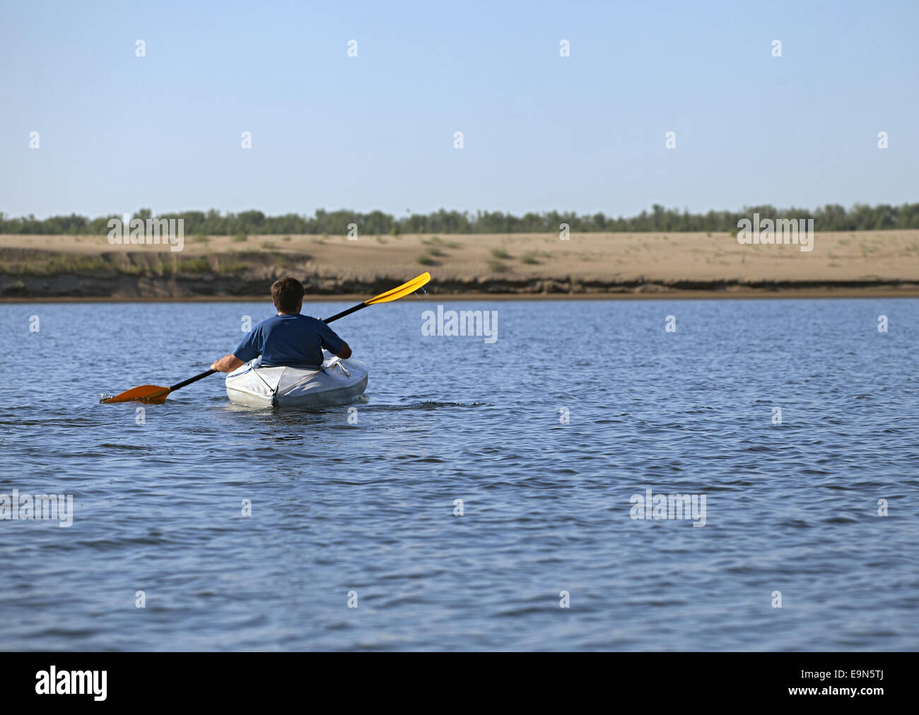 Back of a man rowing in the canoe Stock Photo - Alamy