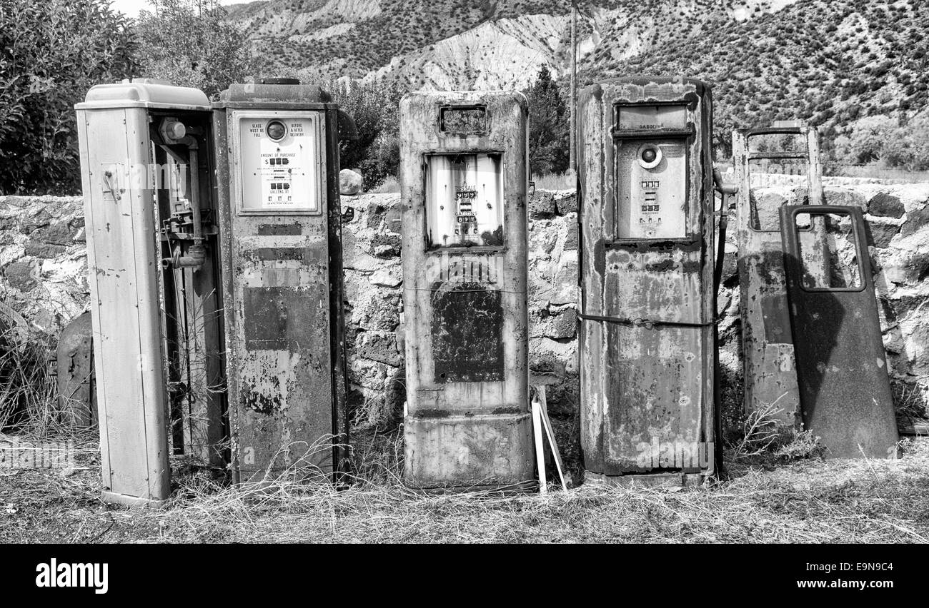 Black and White image of a collection of old rusting gas pumps found in an antique store in New Mexico Stock Photo