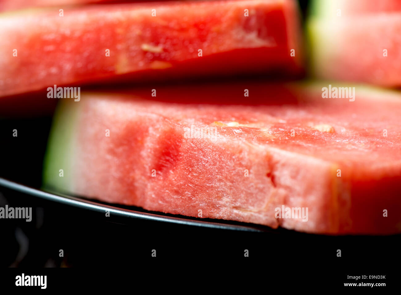 Red watermelon in plate on wooden table Stock Photo