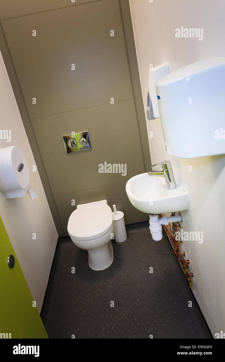 Individual toilet cubicle with wash hand basin Stock Photo