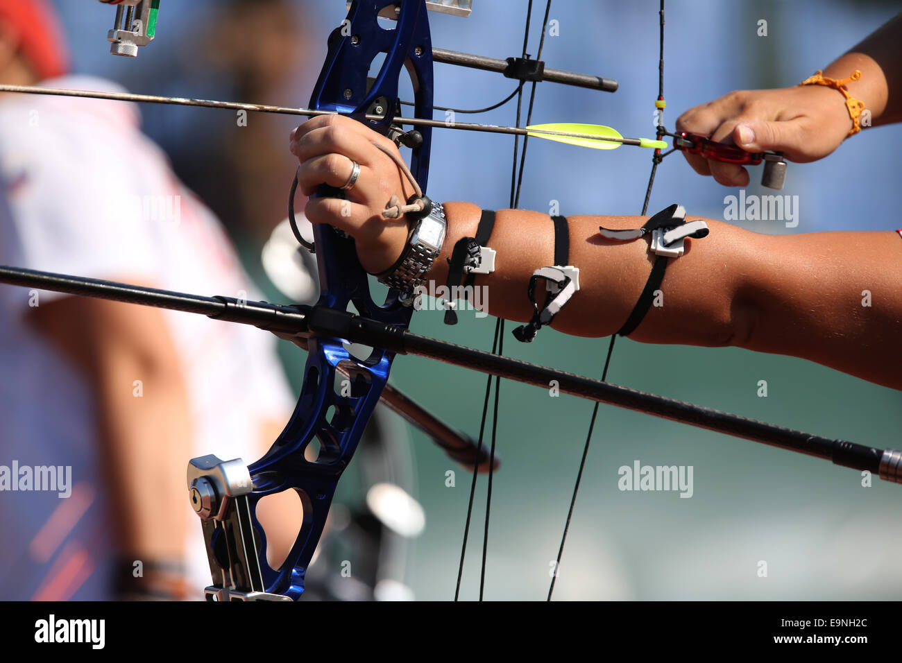 Bow and arrow in the hands of an archer. Stock Photo