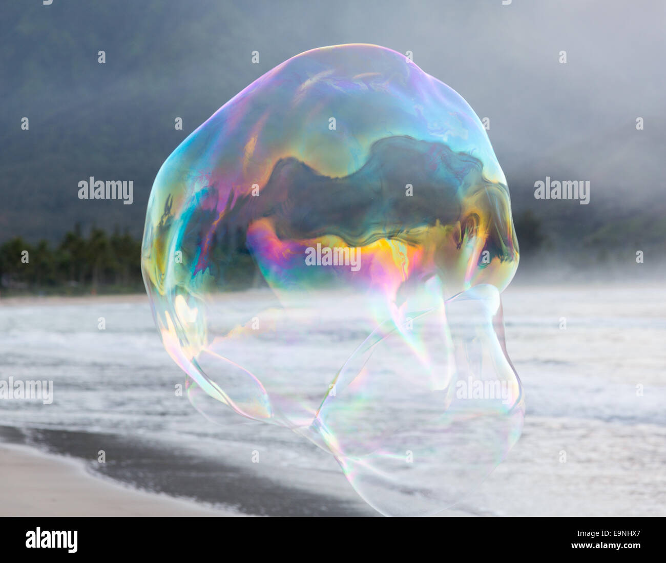Man making large soap bubbles on beach Stock Photo Alamy