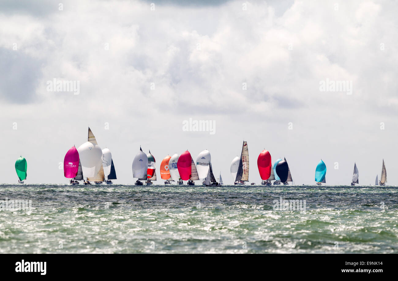 Yachts race downwind under spinnakers on the opening day of Aberdeen Asset Management Cowes Week. The event began in in 1826 and Stock Photo