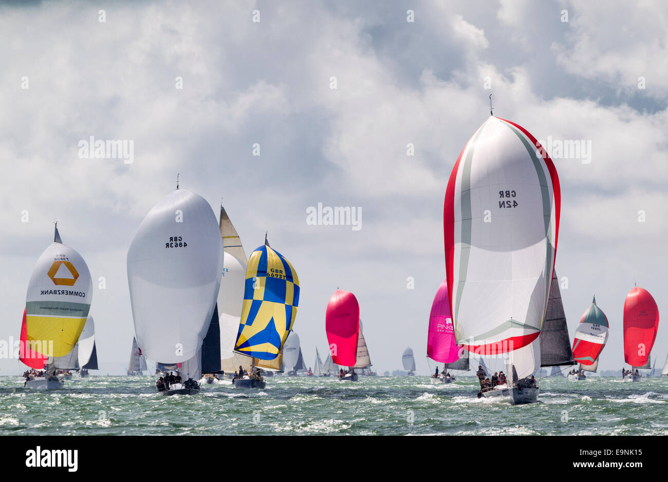 Yachts race downwind under spinnakers on the opening day of Aberdeen Asset Management Cowes Week. The event began in in 1826 and Stock Photo