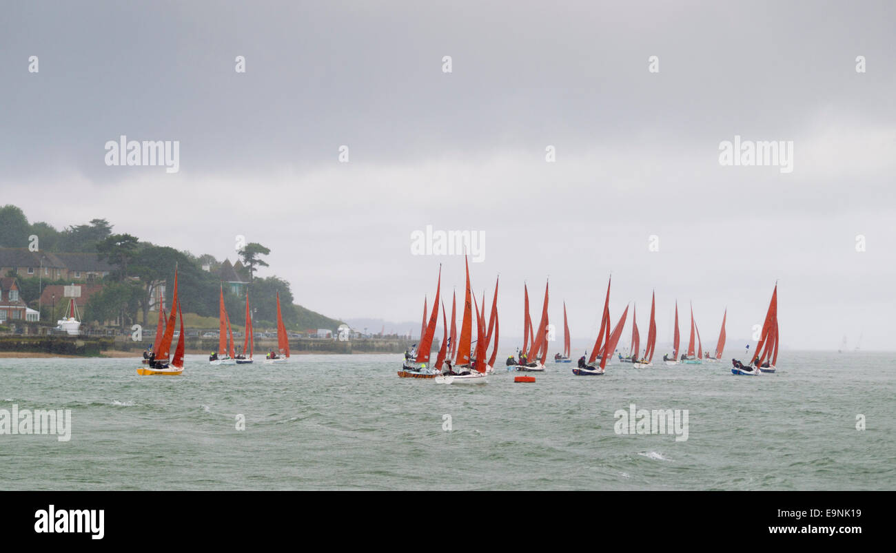 A squall hits the Squib fleet on the opening day of Aberdeen Asset Management Cowes Week. The event began in in 1826 and plays a Stock Photo