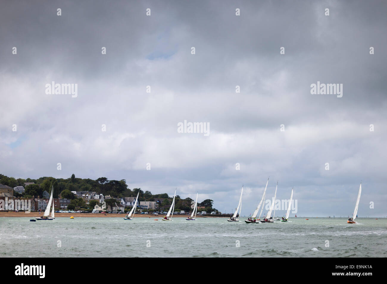 The Solent Sunbeam fleet racing under inclement skies on the opening day of Aberdeen Asset Management Cowes Week. The event bega Stock Photo