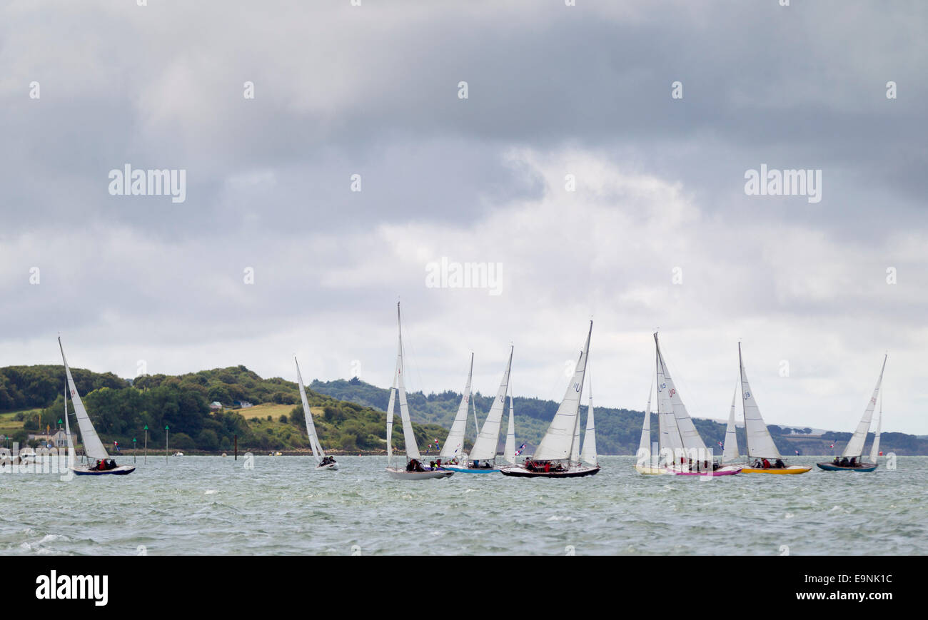 The Solent Sunbeam fleet racing under inclement skies on the opening day of Aberdeen Asset Management Cowes Week. The event bega Stock Photo