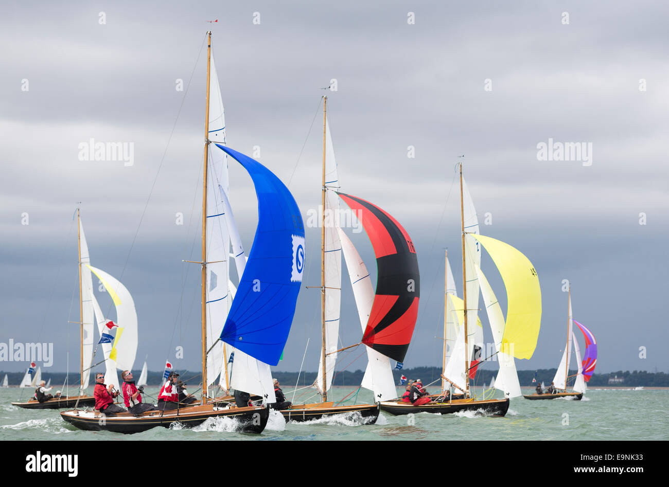 The Victory class fleet racing under spinnakers during Aberdeen Asset Management Cowes Week. The event began in in 1826 and play Stock Photo