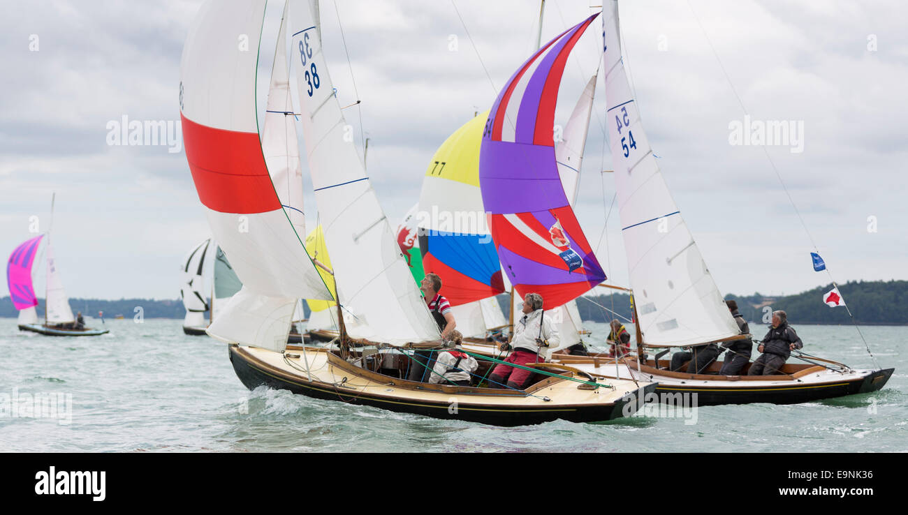 The Victory class fleet racing under spinnakers during Aberdeen Asset Management Cowes Week. The event began in in 1826 and play Stock Photo