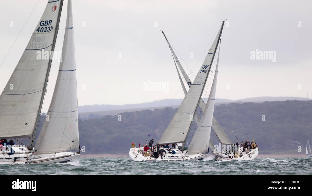 Yachts in the Sunsail fleet cross as they race upwind during Aberdeen Asset Management Cowes Week. The event began in in 1826 an Stock Photo