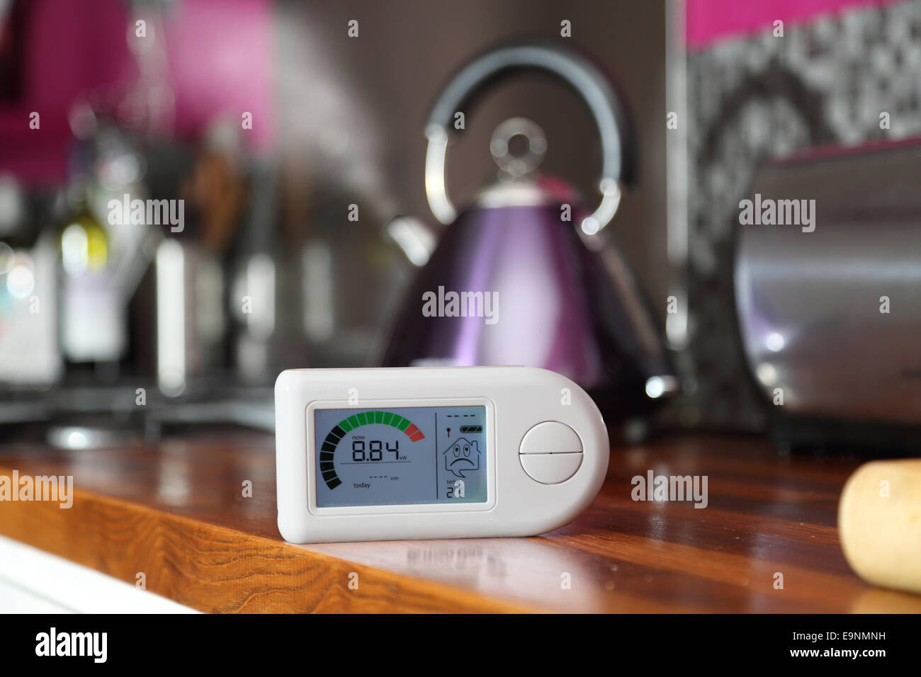 A domestic electricity monitor in a kitchen showing a high level of energy consumption - 8.84Kw Stock Photo