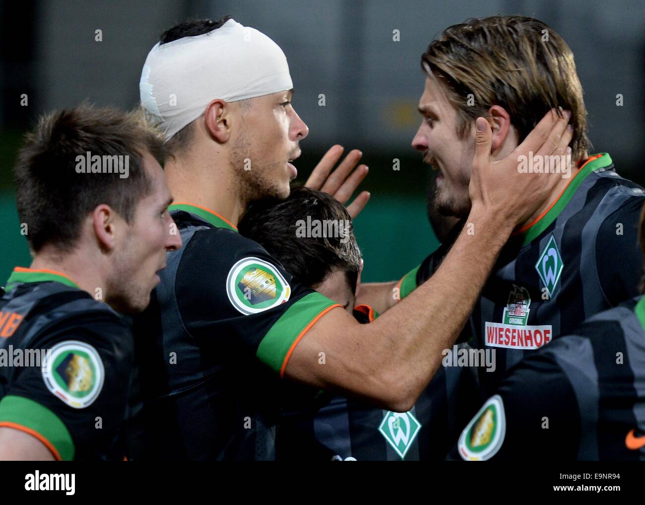 Chemnitz, Germany. 28th Oct, 2014. Bremen's Izet Hajrovic, Franco Di Santo and Sebastian Proedl (R-L) celebrate the 2-0 goal during the DFB Cup second round match between Chemnitzer FC and Werder Bremen at the Stadium on Gellerstrasse in Chemnitz, Germany, 28 October 2014. Photo: HENDRIK SCHMIDT/dpa/Alamy Live News Stock Photo