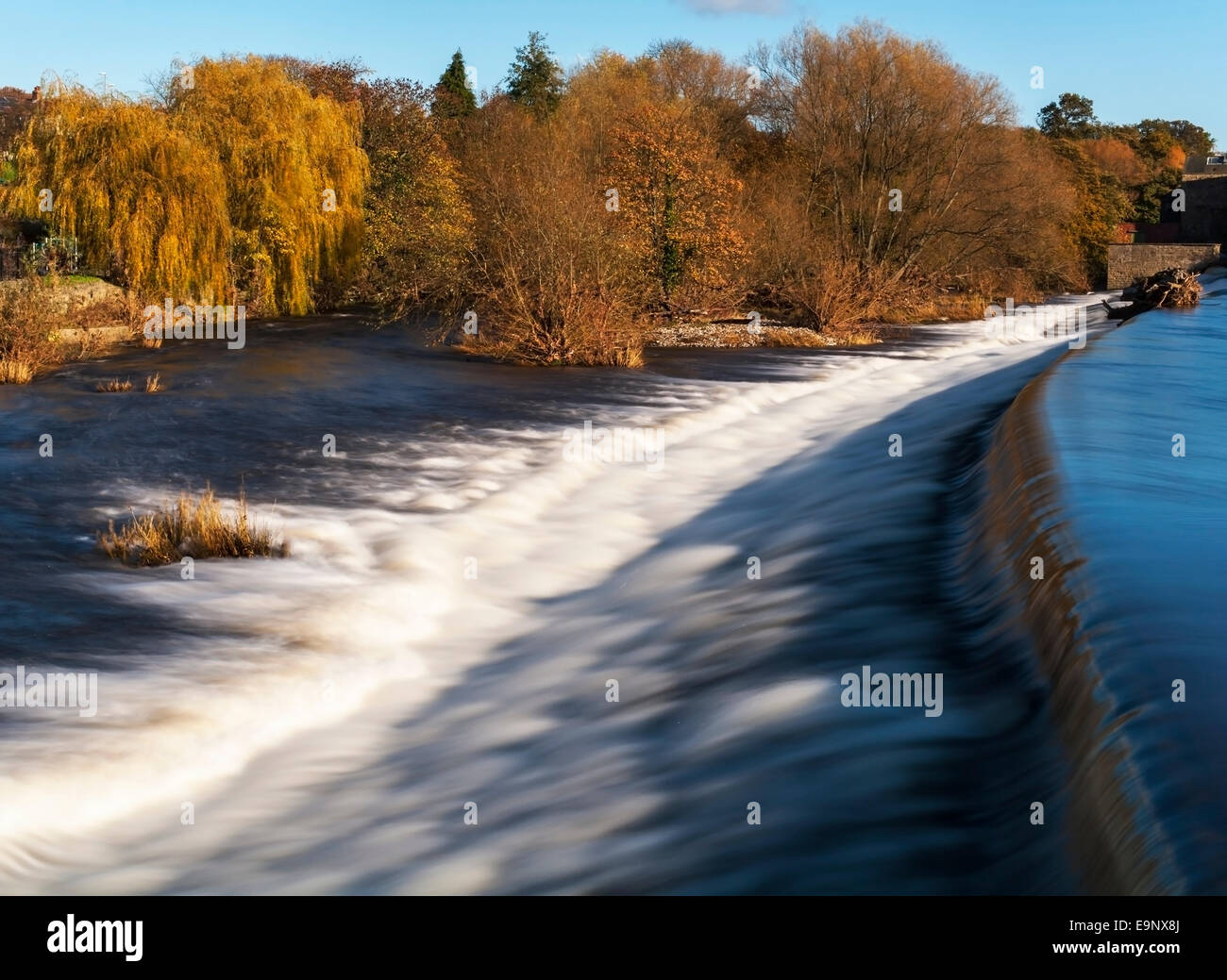 Looking along the weir on the River Wharfe at Otley West Yorkshire on a bright autumn day. Stock Photo