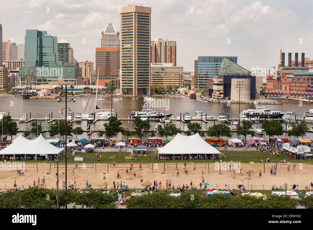 Baltimore's Inner Harbor hosting a beach volleyball tournament and a