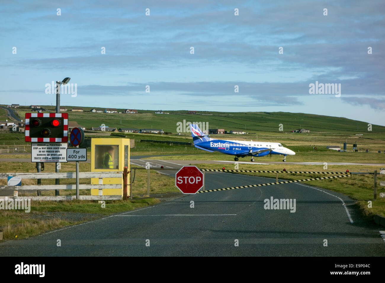 Road closed at Sumburgh airport to allow plane to take off, Sumburgh, Shetland Islands Stock Photo