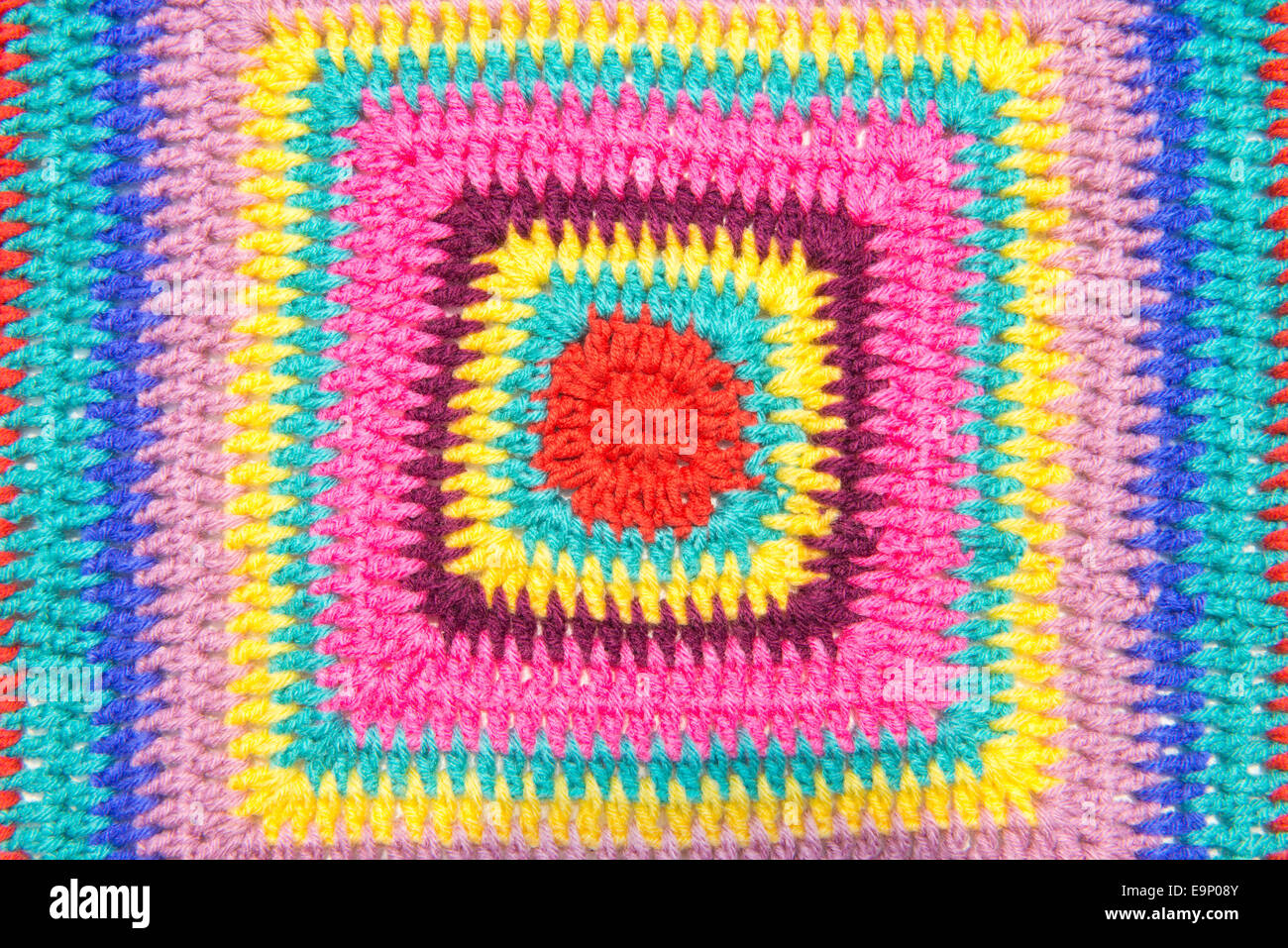 Colseup of crochet colorful fabric pattern. Homemade. Stock Photo