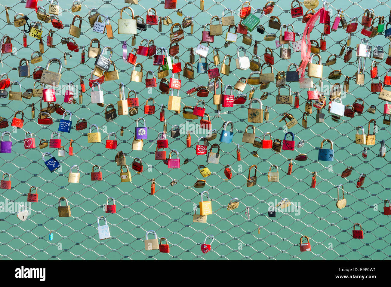 A many of locks on the bridge which the friends or lovers hanging as a symbol of loyalty and eternal love Stock Photo