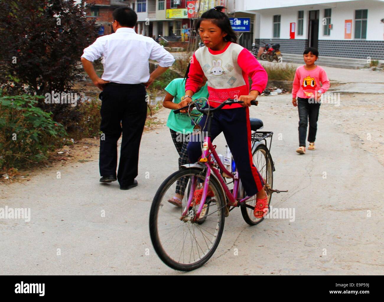 Oct. 27, 2014 - (CHINA OUT) Only for use outside China. Do not use for sale or exhibit in China. XINGGUO CHINA OCT 30: the left-behind children's life after class in Sanliao county, Ganzhou city, Jiangxi Province of China. Their parents had emigrated from the rural areas to the cities. This has created millions of children left behind in the rural areas under the care of relatives, mostly grandparents with little or no education, family friends, or having to take care of themselves. Often, the caretakers do not have the physical ability, financial means nor possess the knowledge needed to take Stock Photo