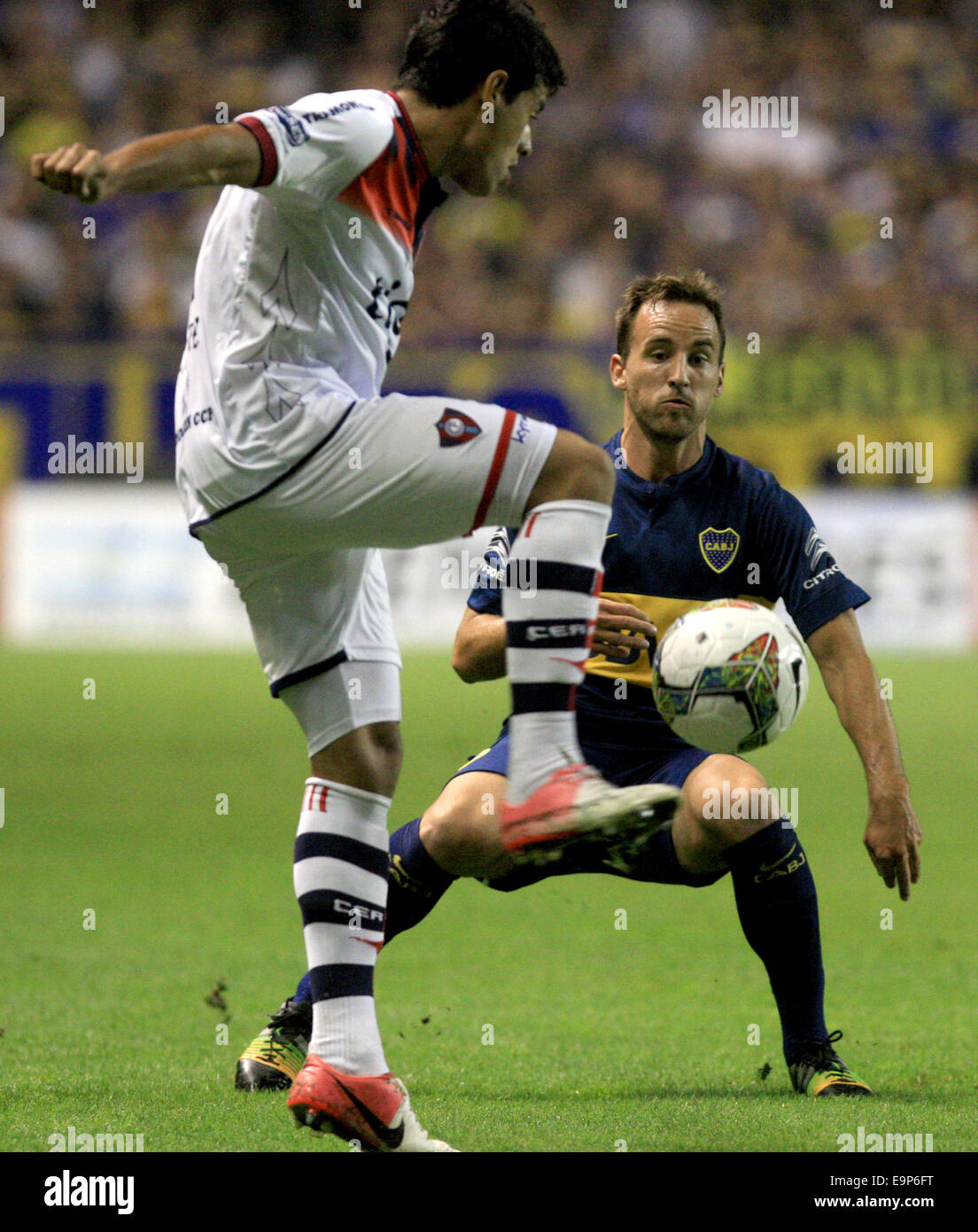 Buenos Aires, Argentina. 30th Oct, 2014. Jose Fuenzalida (R) of Argentina's Boca Juniors vies with Cesar Benitez of Paraguay's Cerro Porteno during the first leg of the quarterfinals of the South American Cup at Alberto J. Armando stadium in Buenos Aires city, Argentina, on Oct. 30, 2014. Credit:  Martin Zabala/Xinhua/Alamy Live News Stock Photo