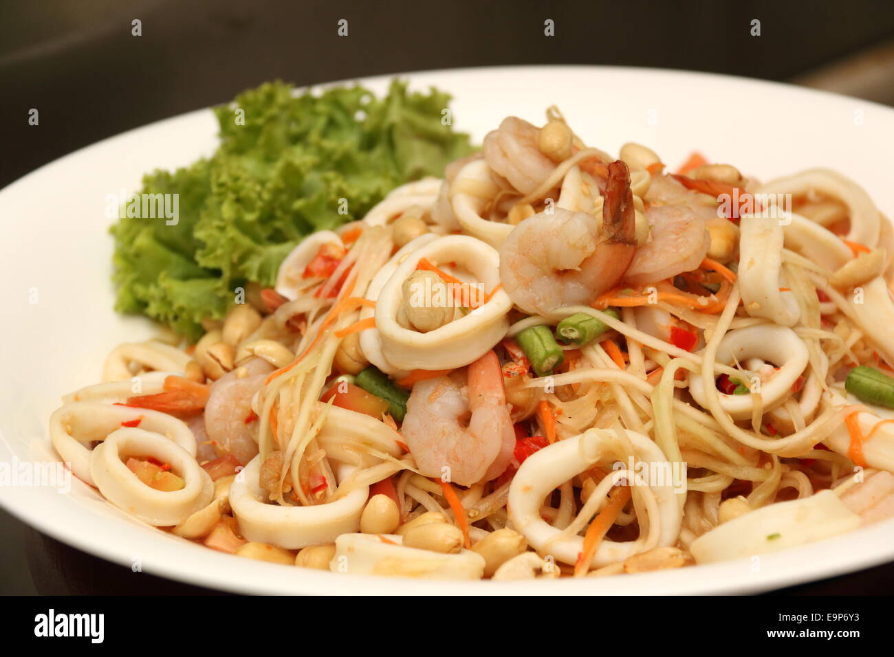 Asian spicy squid salad on white plate Stock Photo - Alamy