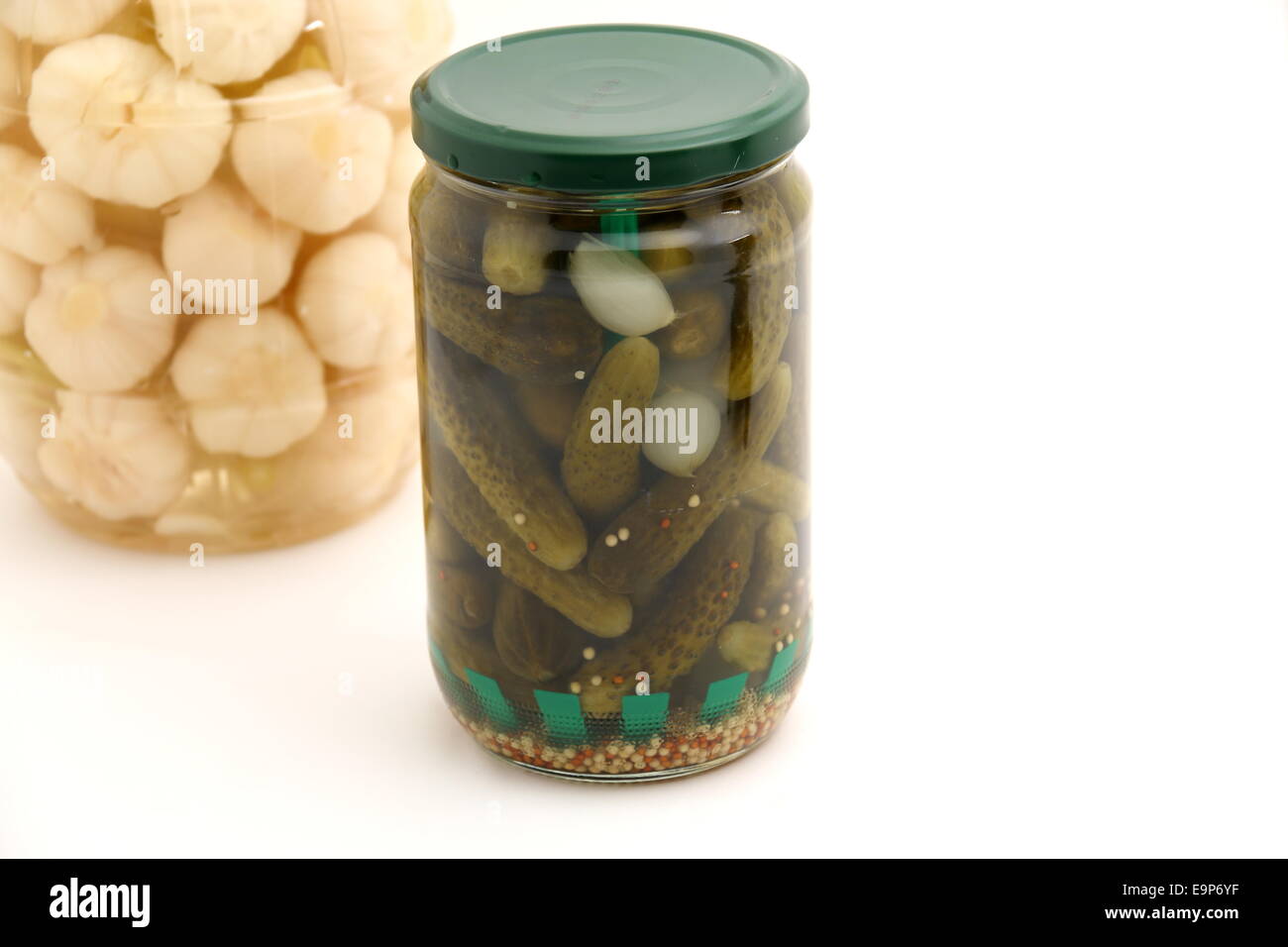 Pickled cucumber in glass jar isolated on white background Stock Photo