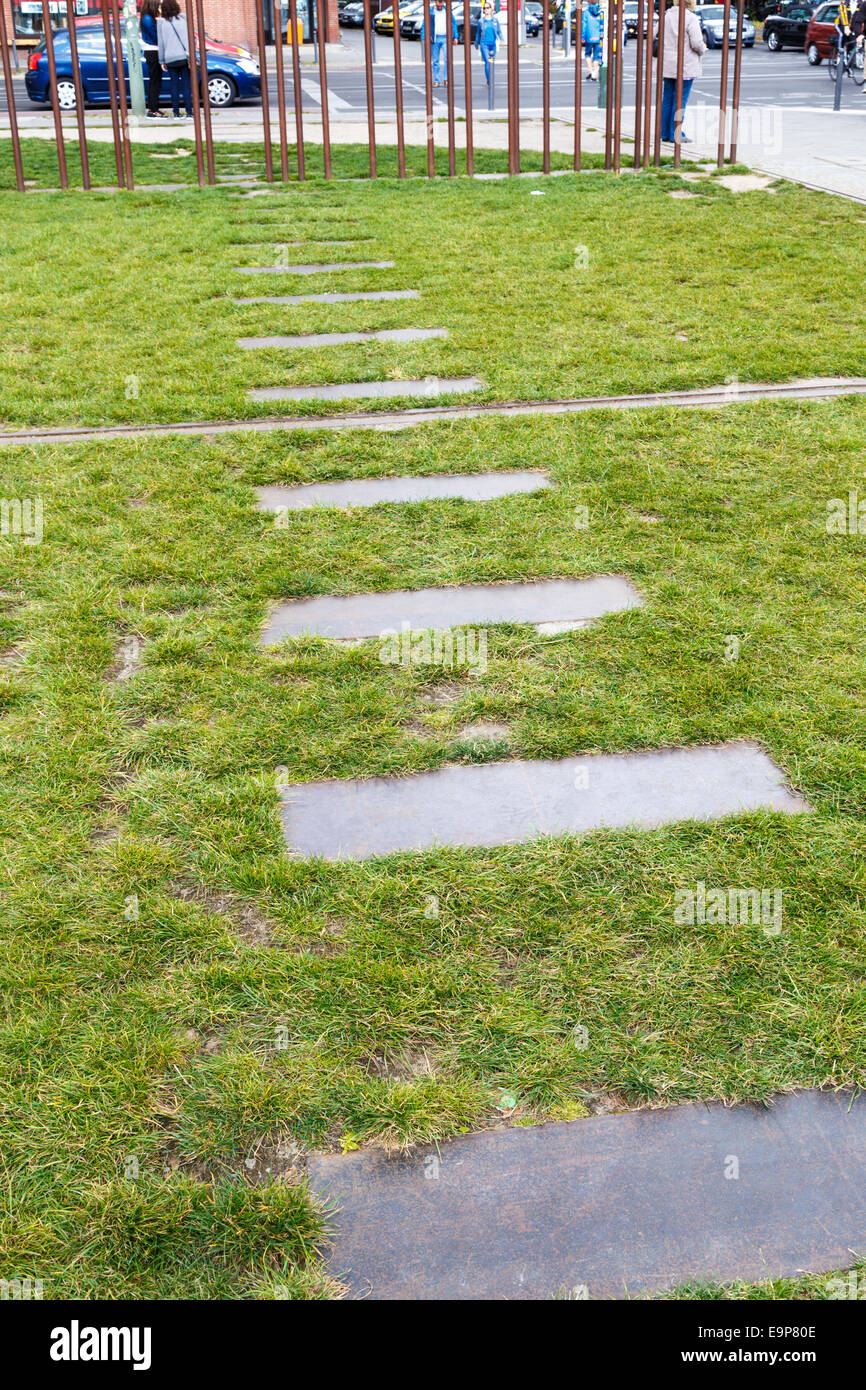 Concrete pavers mark the path of escape tunnels under the death strip at Berlin Wall Memorial Park on Bernauer Strasse, Berlin Stock Photo