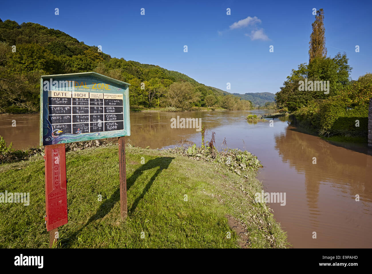 'Tidal Zone' information board, with high tide causing flooding, Brockweir, River Wye, Forest of Dean, Gloucestershire, England, September Stock Photo