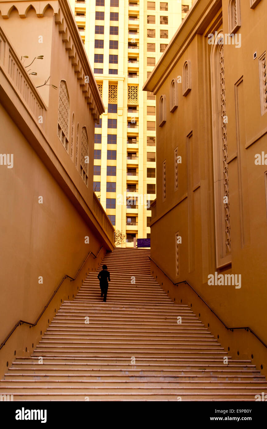 Lone figure climbing steps in Dubai Stock Photo