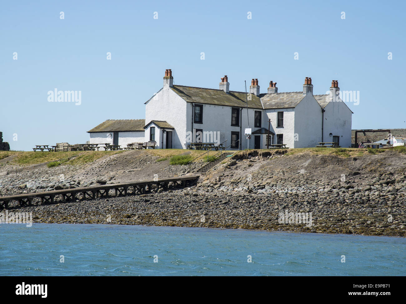 View of causeway and 18th century public house near coast, The Ship Inn, Piel Channel, Piel Island, Islands of Furness, Barrow-in-Furness, Cumbria, England, July Stock Photo
