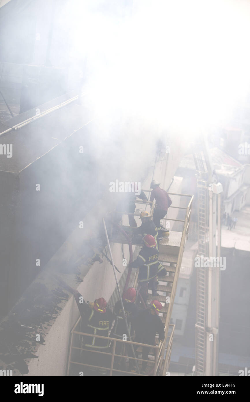 Dhaka, Bangladesh. 31st Oct, 2014. Fire man trying to controll fire using water.A devastating fire has broken out in the office of Bangla national daily Amar Desh housed at Bangladesh Steel and Engineering Corporation (BSEC) building in the capital's Kawran Bazar.Fire service sources said a total of 20 fire fighting units rushed to the scene, and are trying to bring the blaze under control.Earlier on Feb 26, 2007, offices of 10 institutions including media units the NTV, RTV and Amar Desh were destroyed in a fire incident at the same building. (Credit Image: © Zakir Hossain Chowdhury/ZUMA Stock Photo