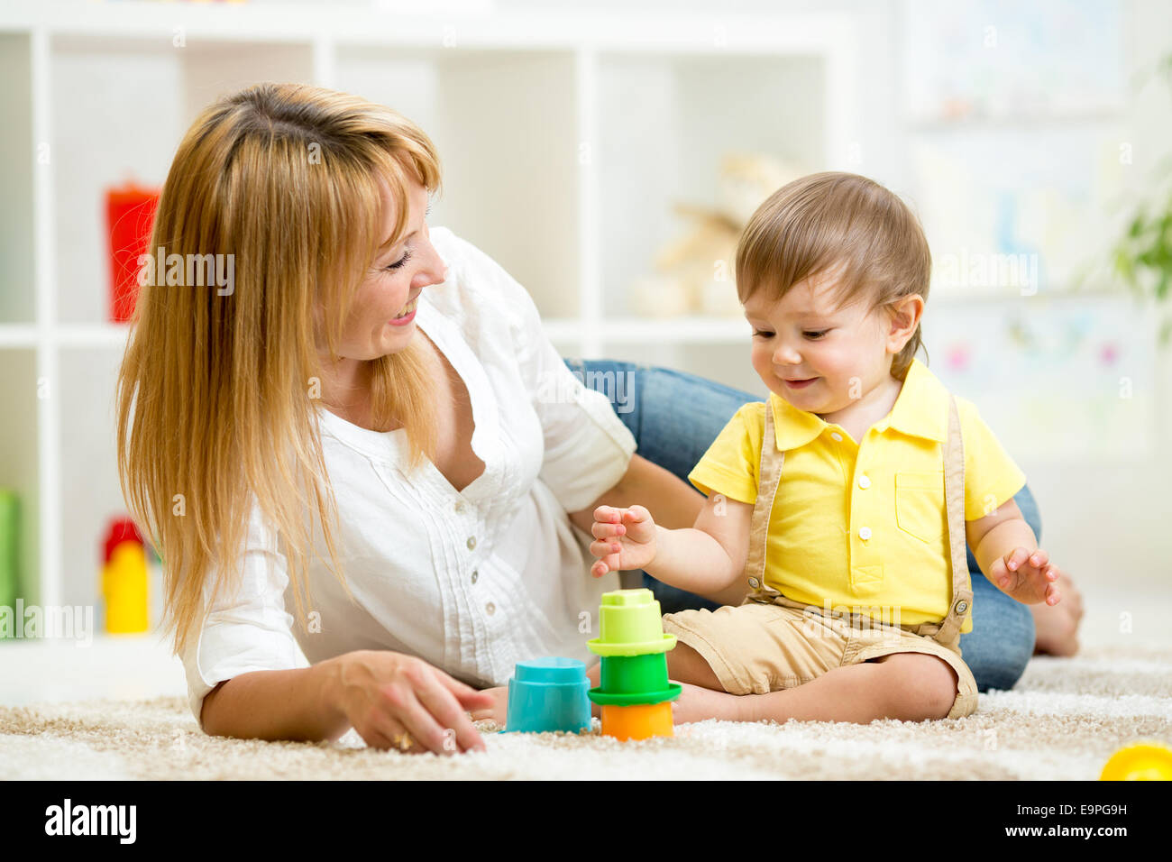 little child and woman playing with toys Stock Photo - Alamy