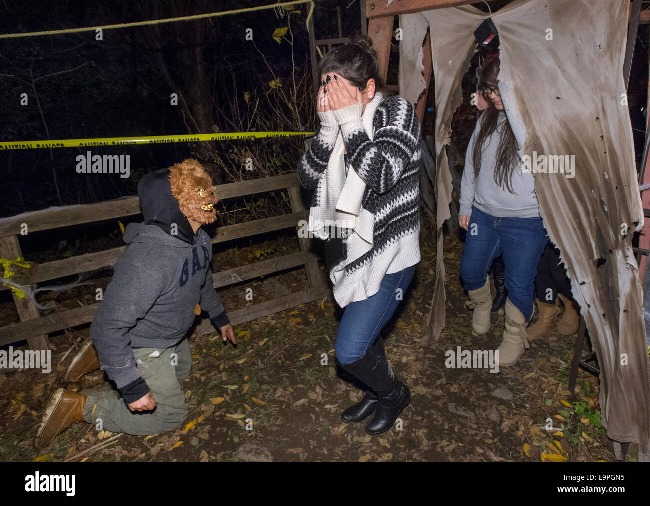Montreal, Canada. 30th Oct, 2014. A frightened girl reacts in the Halloween Haunted Woods on the Mohawk reserve of Kahnawake near Montreal, Canada, Oct. 30, 2014. More than 10 volunteers wearing frightening costumes scare and entertain visitors during the Halloween season here. The two-day activity also collects food and donations for the local food bank. Credit: Andrew Soong/Xinhua/Alamy Live News Stock Photo