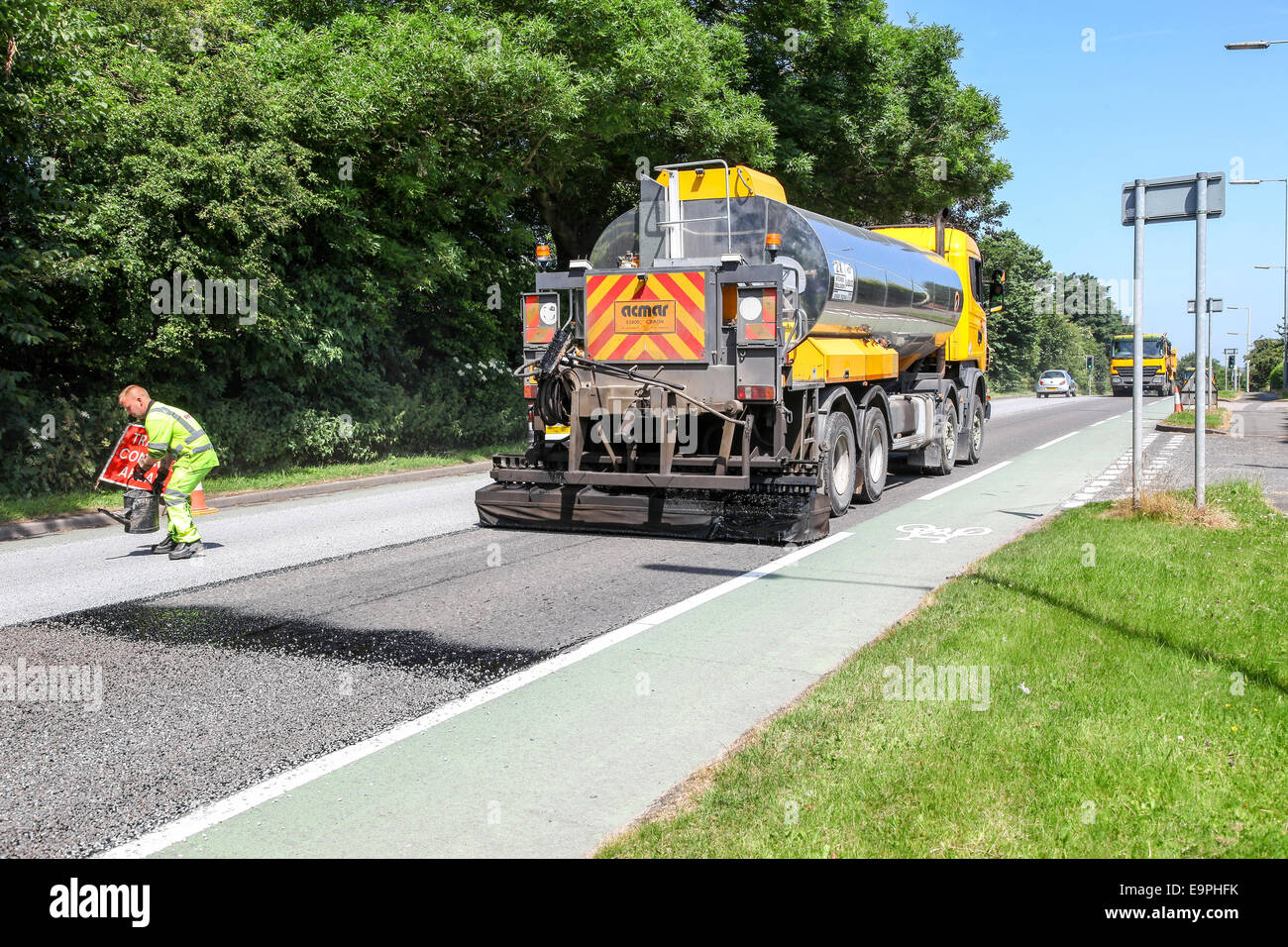 A lorry or truck tarmacing or laying tarmac on a main road Stoke-on-Trent, Staffordshire, England, UK Stock Photo